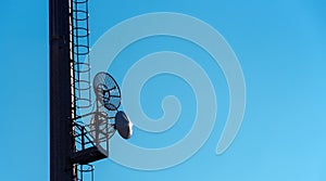 Telecommunication satellite dishes on blue sky