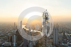 Telecommunication tower with 5G cellular network antenna on city background