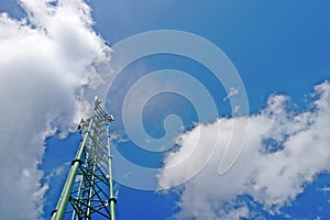 Telecommunication tower antenna on blue sky and cloud background