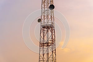 Telecommunication tower Antenna and satellite dish with evening sky