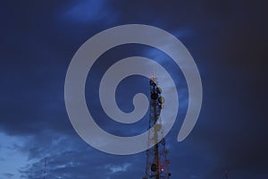 Telecommunication tower Antenna and satellite dish at sunset sky