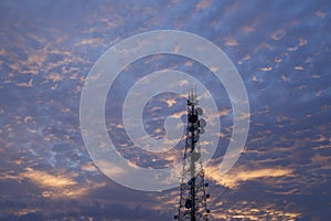 Telecommunication tower Antenna and satellite dish at sunset sky