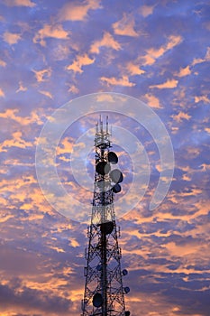 Telecommunication tower Antenna and satellite dish at sunset sky