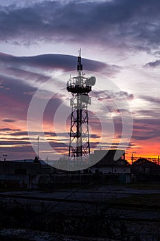 Telecommunication tower Antenna and satellite dish at sunset sky