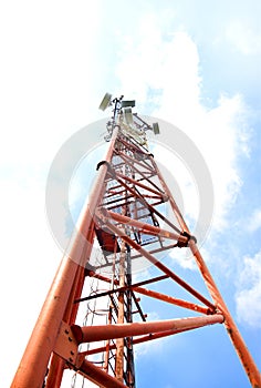 Telecommunication tower with antennas on a background of blue sky and clouds. Smart antennas transmit 4G and 5G cellular signals