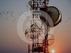 Telecommunication tower Antennas with sunset