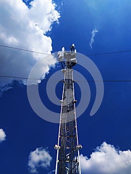 Telecommunication tower on a blue sky background for Internet connection, smartphone, wireless signal. Online service connection