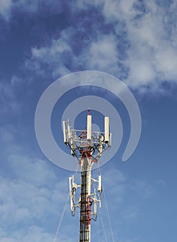 Telecommunication tower with blue sky and cloud