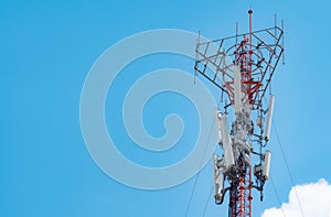 Telecommunication tower with blue sky and white cloud background. The antenna on blue sky. Radio and satellite pole. Communication