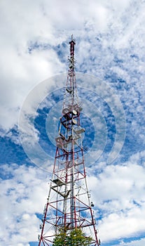 Telecommunication tower with a lot of antennas against blue sky