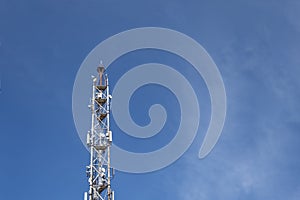 Telecommunication tower with lot of antennas on blue sky