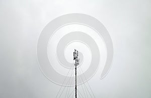 Telecommunication tower or mast against grey sky