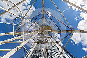 Telecommunication tower or mast with microwave, radio panel antennas, outdoor remote radio units, power cables, coaxial