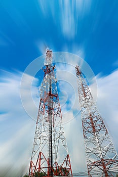 Telecommunication Tower. Mobile Phone Signal Tower on cloudy blue sky background