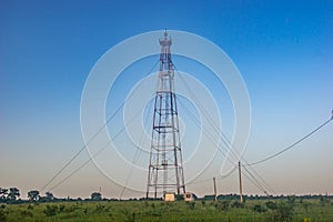 Telecommunication tower in the morning in the field
