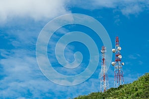 Telecommunication tower on mountain and green tree with blue sky. Antenna on blue sky. Radio and satellite pole. Communication