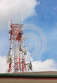 Telecommunication tower,roof and sky cloudy background.