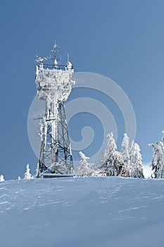Telecommunication tower with snow photo