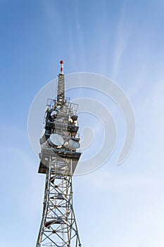 Telecommunication tower with transmitters and aerials, wireless communication and 5G broadband cellular networks concept