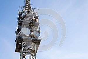 Telecommunication tower with transmitters and aerials, wireless communication and 5G broadband cellular networks concept