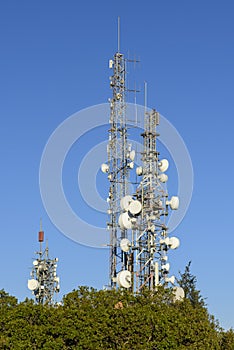 Telecommunication towers with blue sky in the background photo