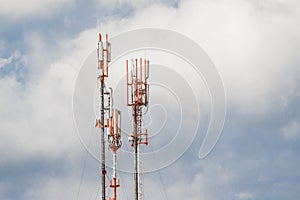 Telecommunication towers of mobile and cellular communication antennas on the background of the sky