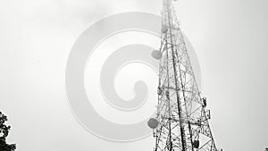The telecommunication towers with TV antennas and satellite dish In the foggy morning on mountain.