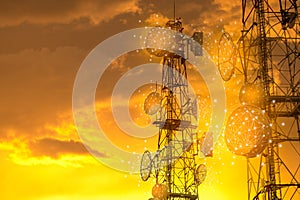Telecommunication towers with wireless antennas on golden sunset sky