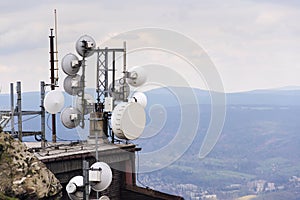 Telecommunication transmitters and aerials with city background photo