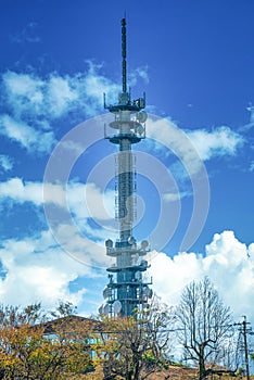 Telecommunications antenna tower for mobile phone with the blue sky background