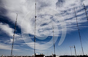 Telecommunications antennas on a cloudy blue sky