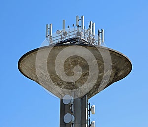 Telecommunications signal antennas and repeaters above the tower