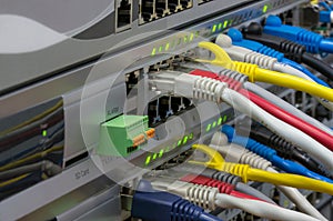 Telecommunications switches with colored patch cords