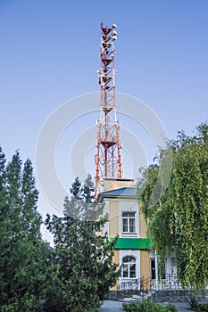 Telecommunications tower against a blue sky .  Radio and satellite pole. Communication technology. Telecommunication industry. Mob