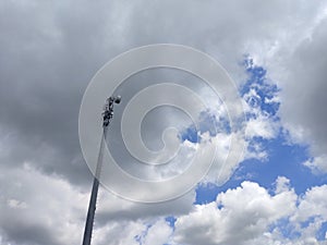 Telecommunications tower against clouds sky background