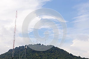 Telecommunications tower on the mountain blue sky background.