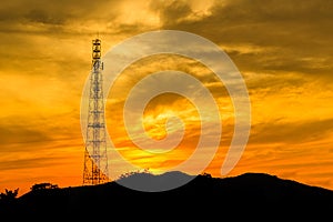 Telecommunications tower with sunset sky.