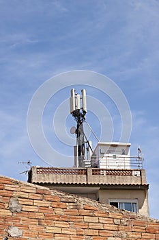 Telecommunications wireless cell phone antennas on the roof of a building. 5g high speed internet transmitters