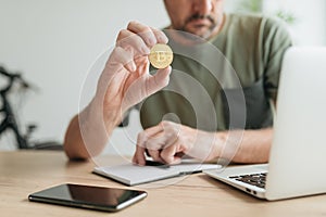 Telecommuter trading with bitcoin cryptocurrency from home office photo