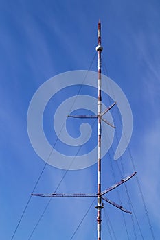 Telecomunication television, radio antenna, satellite tower on blue sky background