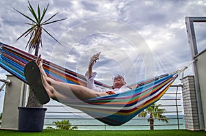 Teleconference from a hammock close to the sea
