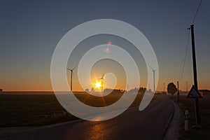 telegraph pole on road before horizon