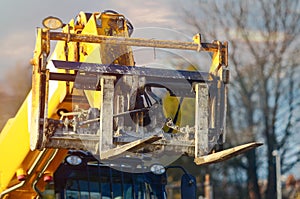 Telehandler with raised boom and forks close-up