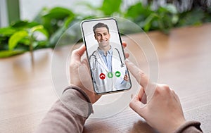 Telehealth Concept. Unrecognizable Female Patient Video Conferencing With Doctor On Smartphone