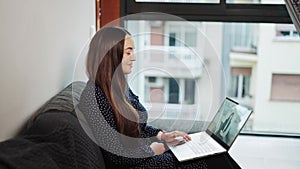 Telehealth. Young happy smiling woman having first online therapy session with psychologist at home