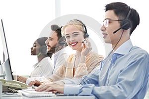 Telemarketing concept. Happy hotline operators selling goods or services through VoIP telephony at call centre