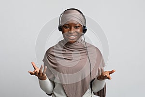 Telemarketin. Black Muslim Woman In Hijab Wearing Headset And Talking At Camera