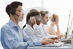 Telemarketing or customer service team providing assistance to clients at call centre office