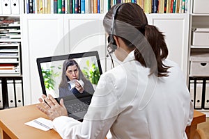 Telemedicine concept: doctor during a video consult with a coughing patient.