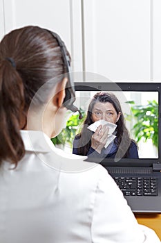 Telemedicine concept: doctor during a video consult with a coughing patient.